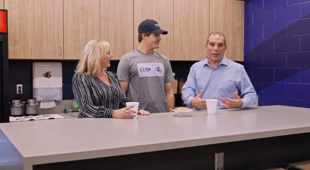 Forward will Howard chats with Dave Starman and Shireen Saski in the kitchen of the hockey team suite