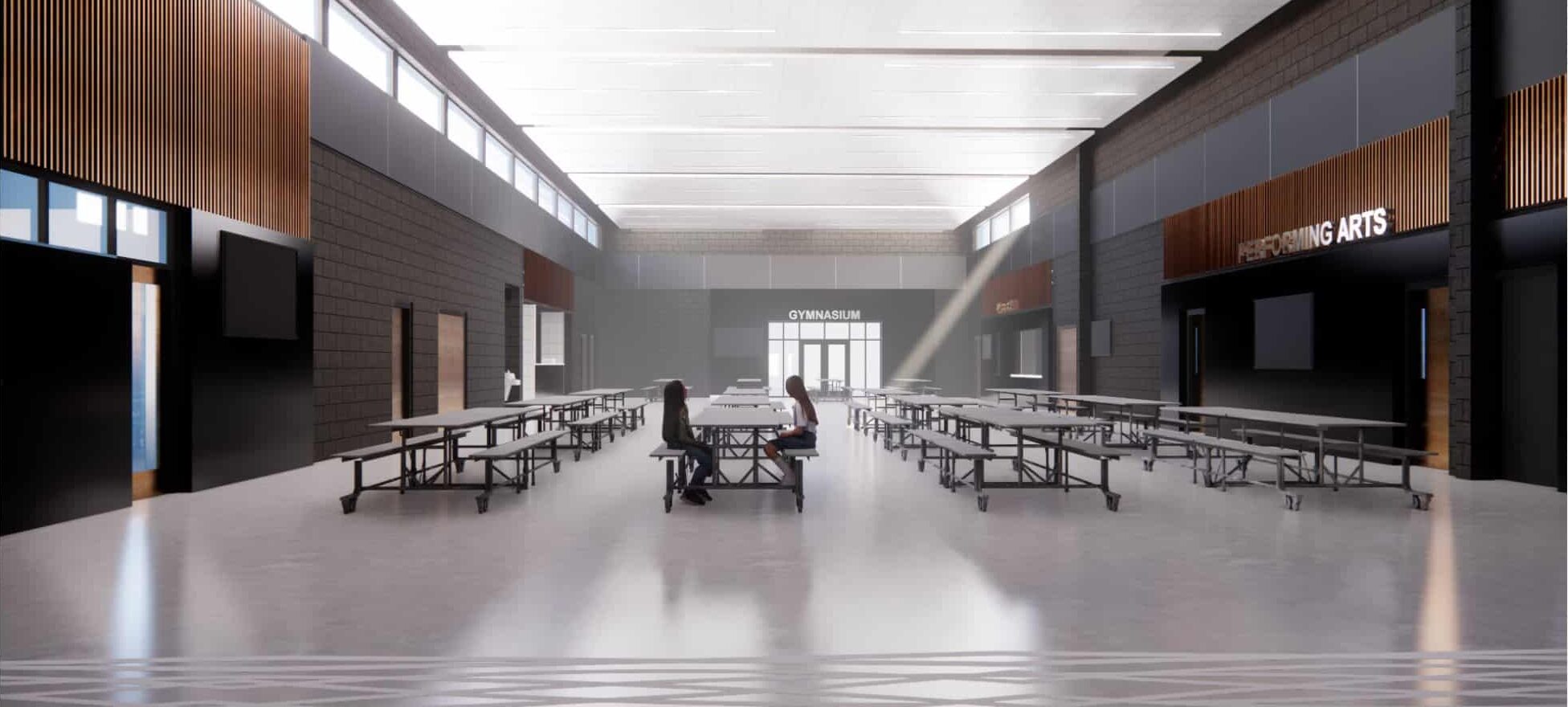 Main commons area with lunch tables and sun light flooding the space