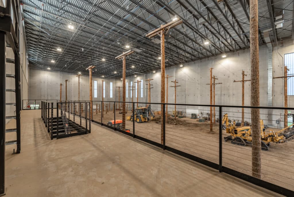 A lineworker training center floor with light poles used for training